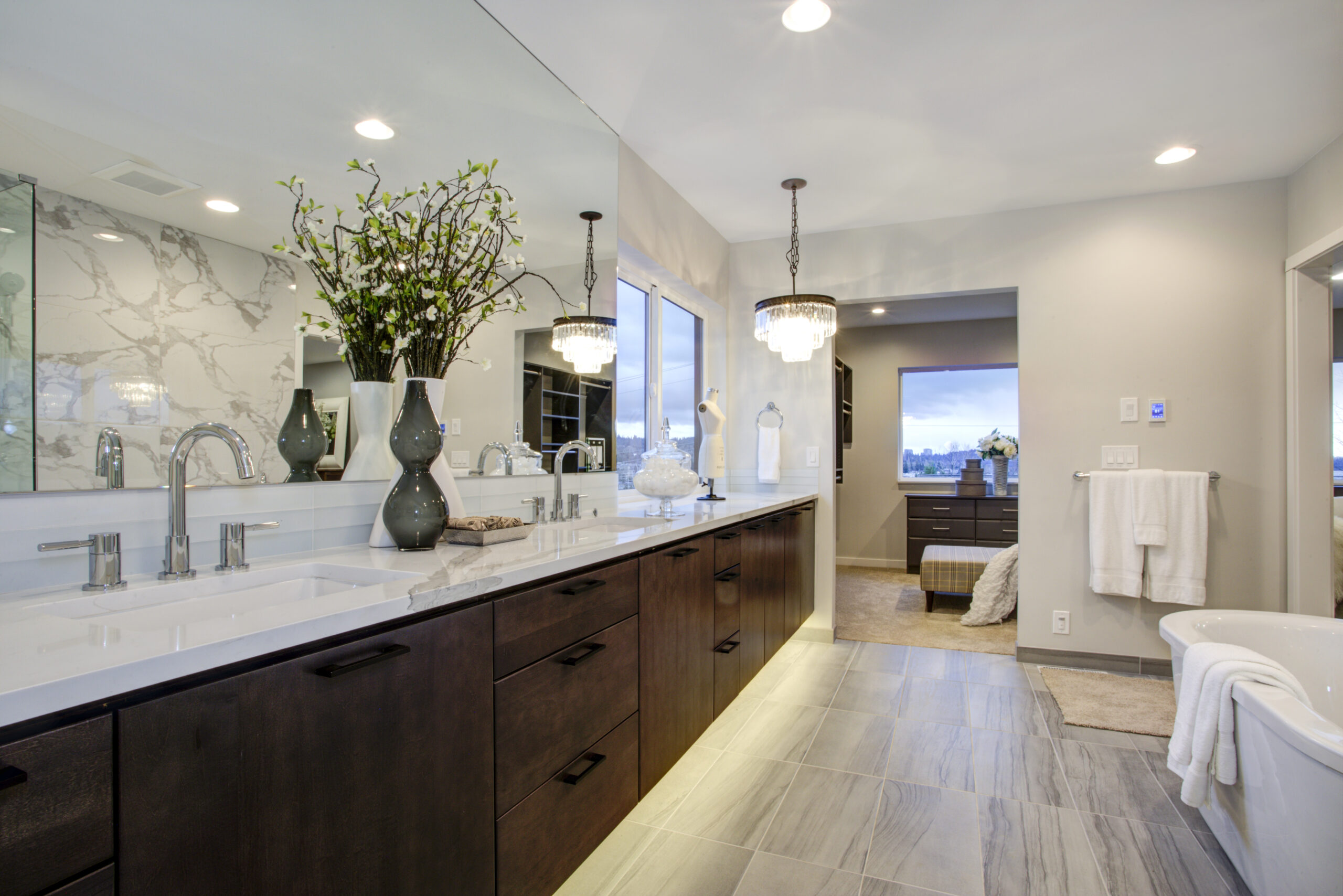 Beautiful open bathroom with large counter, bathtub and a beautiful luxury vinyl floor.